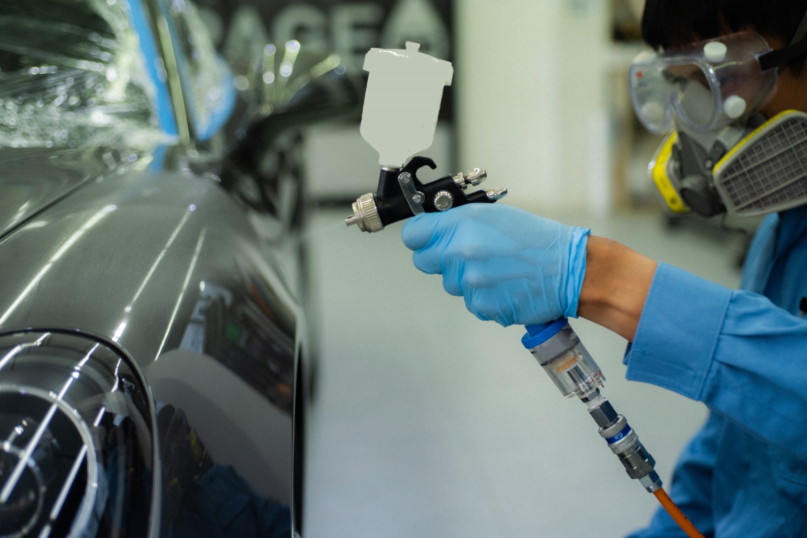 Close-up image of professional car painting, focus on the foregr